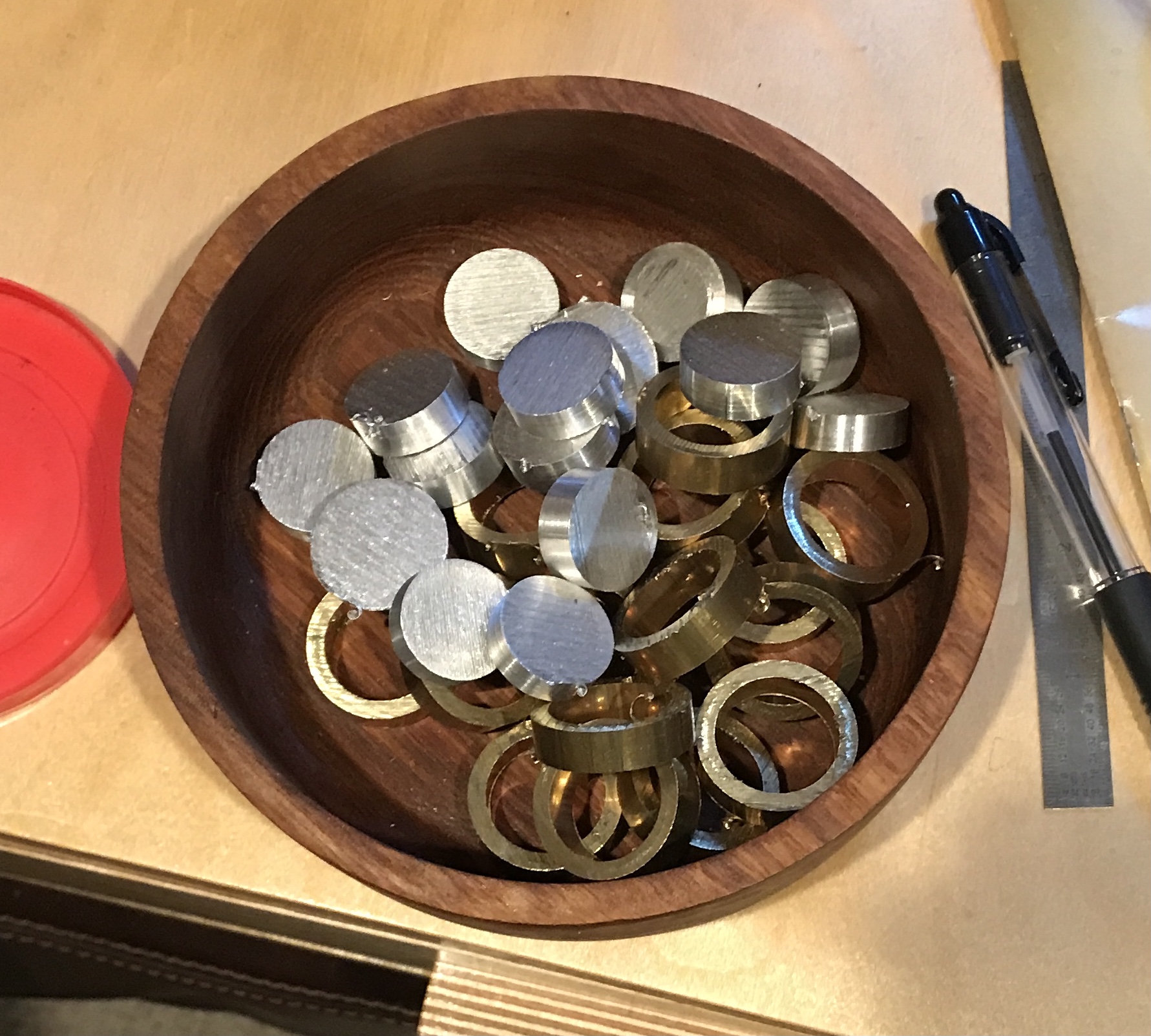 Fifteen brass rings and fifteen aluminum disks.